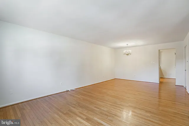 a view of an empty room and wooden floor
