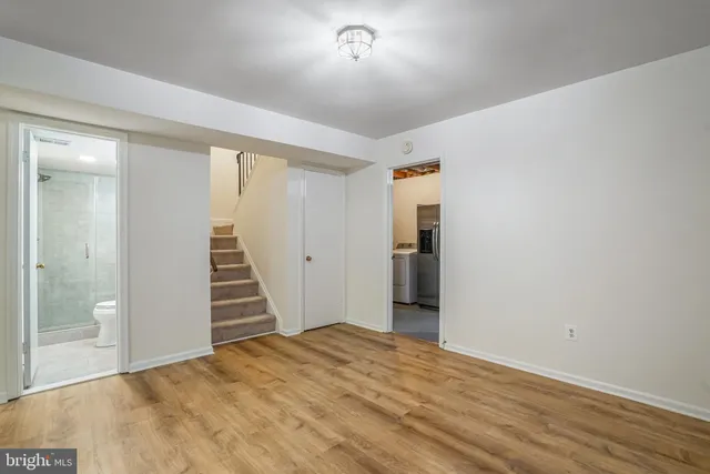 a view of a room with wooden floor and staircase