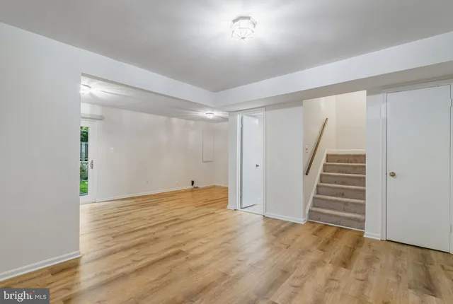 a view of an empty room with stairs and ventilation