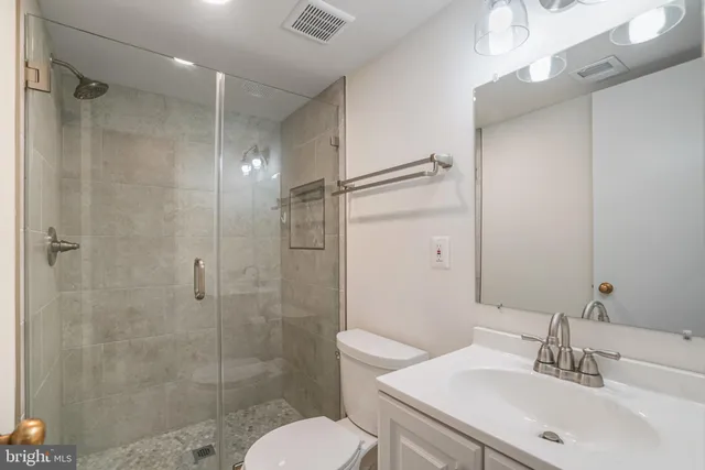 a bathroom with a sink toilet and shower