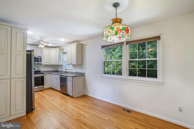 a kitchen with a refrigerator and a window