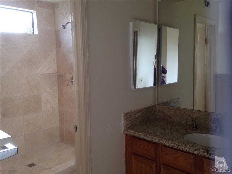 876 Congressional Road Simi Valley, CA 93065 - Photo 6 of 19 a bathroom with a granite countertop sink a mirror and shower