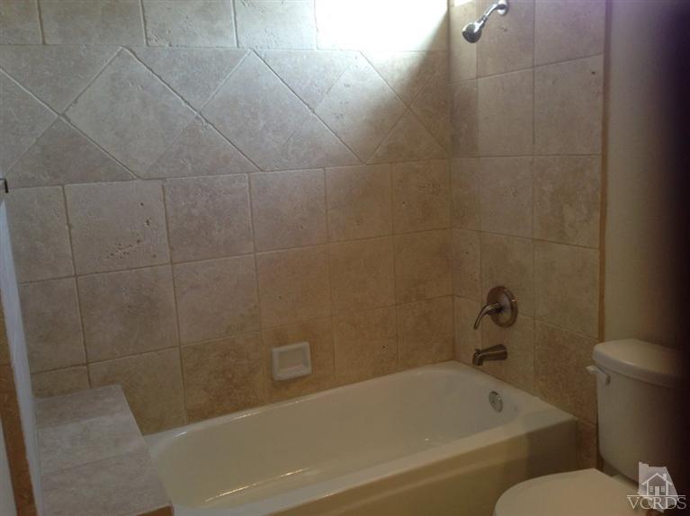 876 Congressional Road Simi Valley, CA 93065 - Photo 7 of 19 a white bath tub sitting next to a toilet