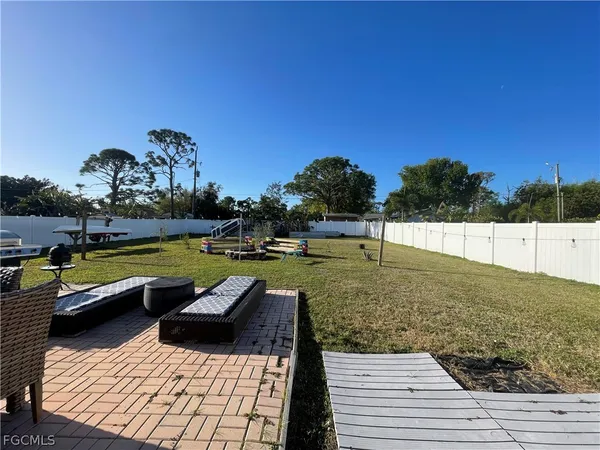 a view of swimming pool with seating space and yard