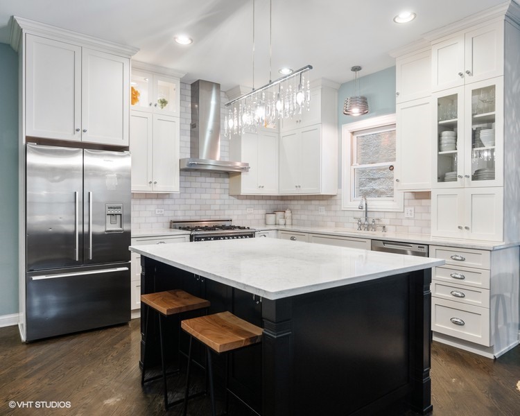 1316 West Fletcher Street, Unit 1E Chicago, IL 60657 - Photo 3 of 13 a kitchen with a sink stainless steel appliances and white cabinets