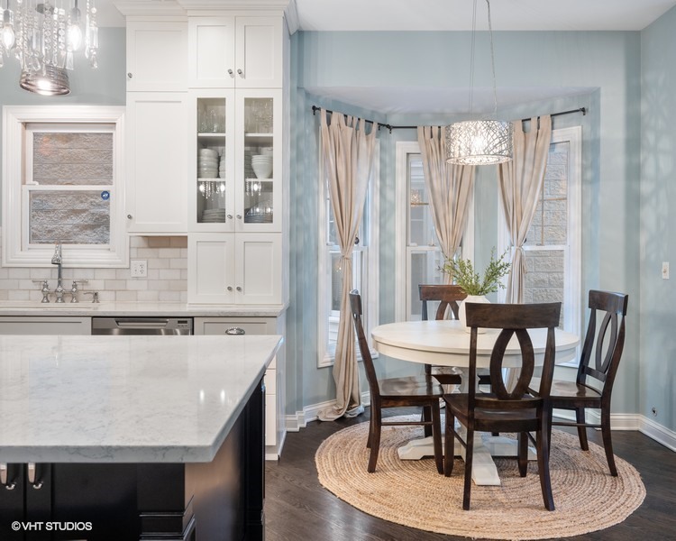 1316 West Fletcher Street, Unit 1E Chicago, IL 60657 - Photo 4 of 13 a view of a dining room with furniture and window