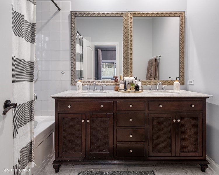 1316 West Fletcher Street, Unit 1E Chicago, IL 60657 - Photo 6 of 13 a bathroom with a sink vanity and mirror