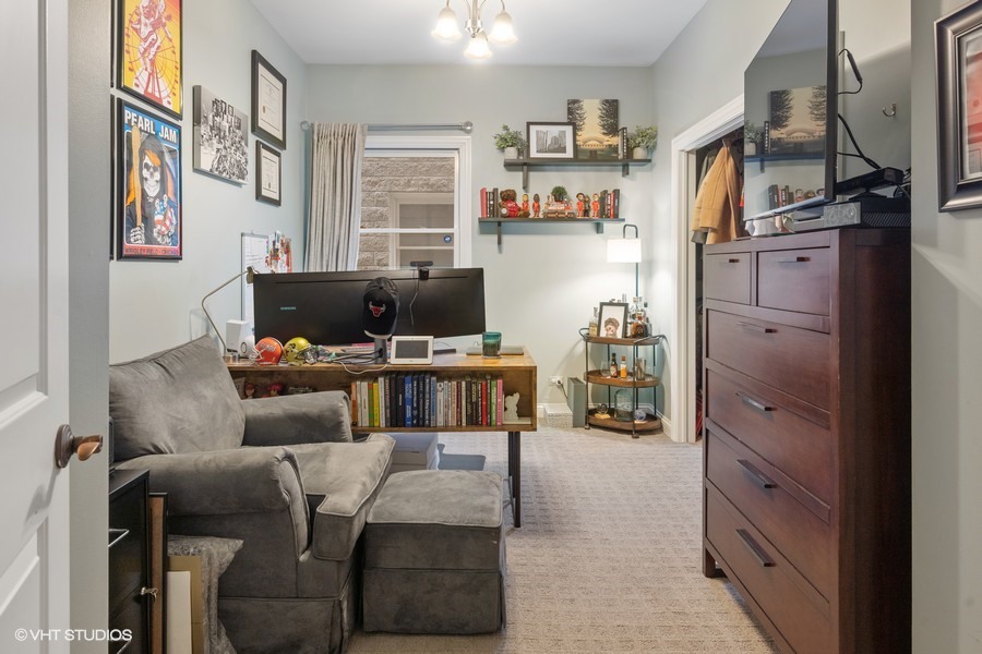 1316 West Fletcher Street, Unit 1E Chicago, IL 60657 - Photo 7 of 13 a living room with furniture cabinets and a window