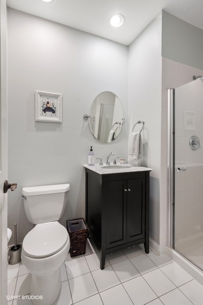 1316 West Fletcher Street, Unit 1E Chicago, IL 60657 - Photo 8 of 13 a bathroom with a toilet sink and vanity