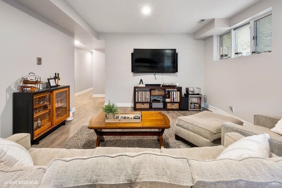 1316 West Fletcher Street, Unit 1E Chicago, IL 60657 - Photo 9 of 13 a living room with furniture and a flat screen tv