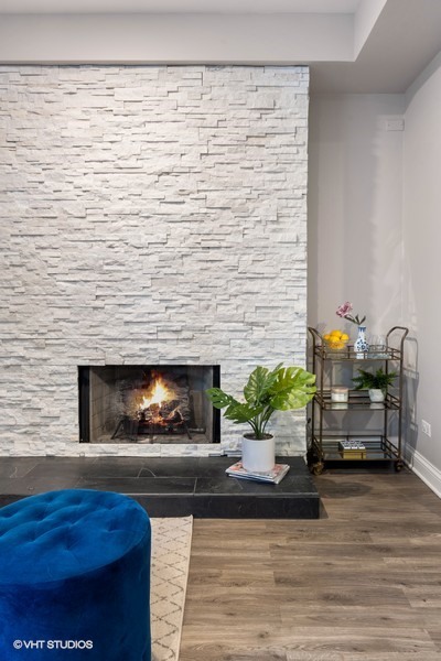 1316 West Fletcher Street, Unit 1E Chicago, IL 60657 - Photo 10 of 13 a living room with furniture and a fireplace