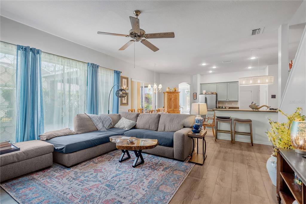 19015 Fern Meadow Loop Lutz, FL 33558 - Photo 21 of 50 a living room with furniture and a dining table with wooden floor