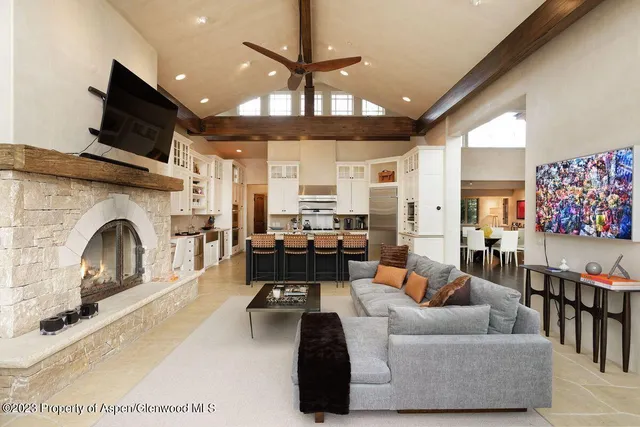 a living room with furniture gym equipment and a fireplace