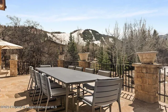 a view of a patio with iron fence