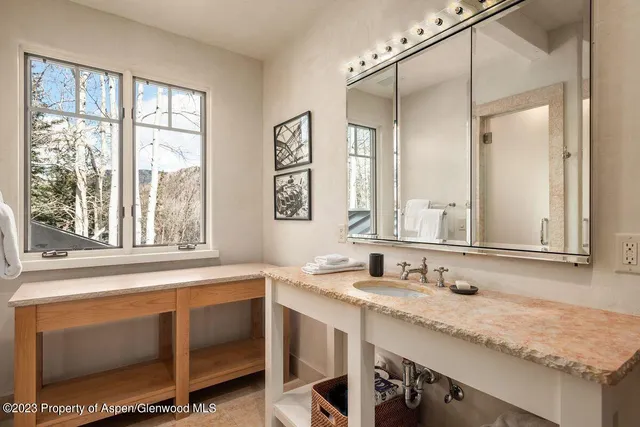 a bathroom with a granite countertop sink mirror and double