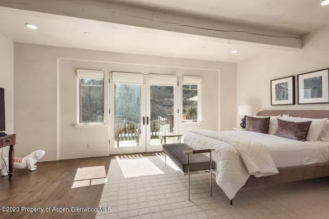 a bedroom with a large bed and a large window