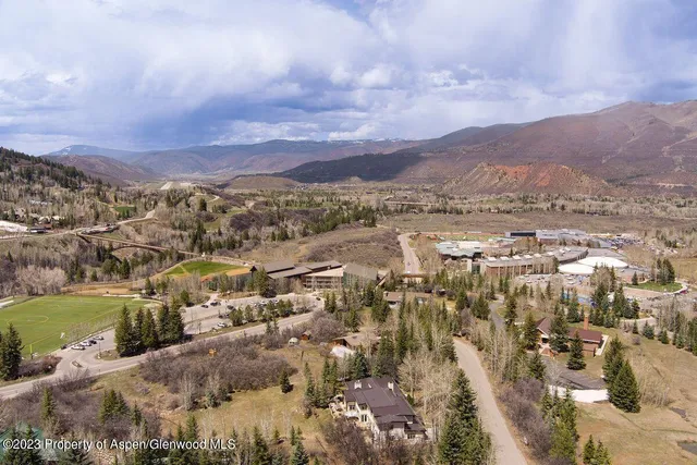 an aerial view of residential houses with outdoor space and river