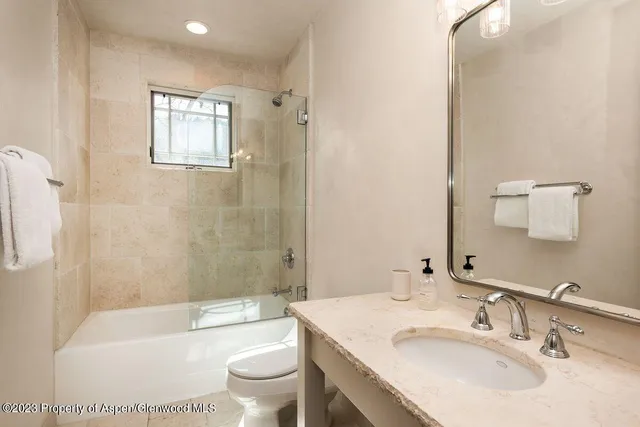 a bathroom with a sink toilet tub and shower