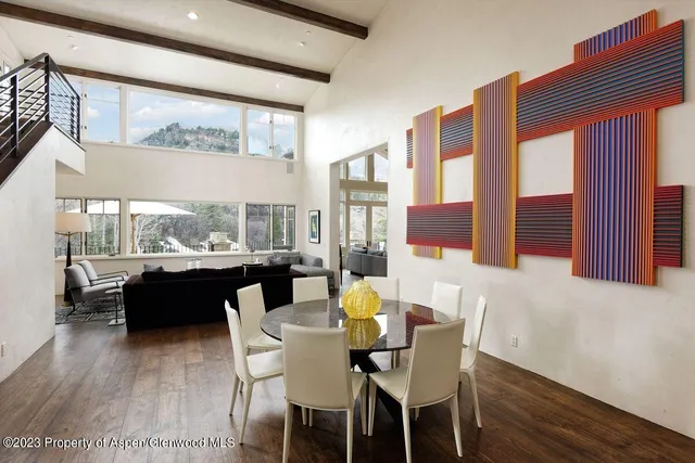 a dining room with furniture a fireplace and wooden floor