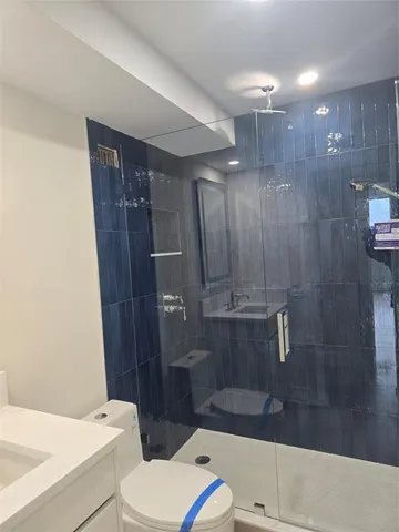 a bathroom with a sink toilet and mirror