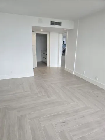 an empty room with windows and entrance