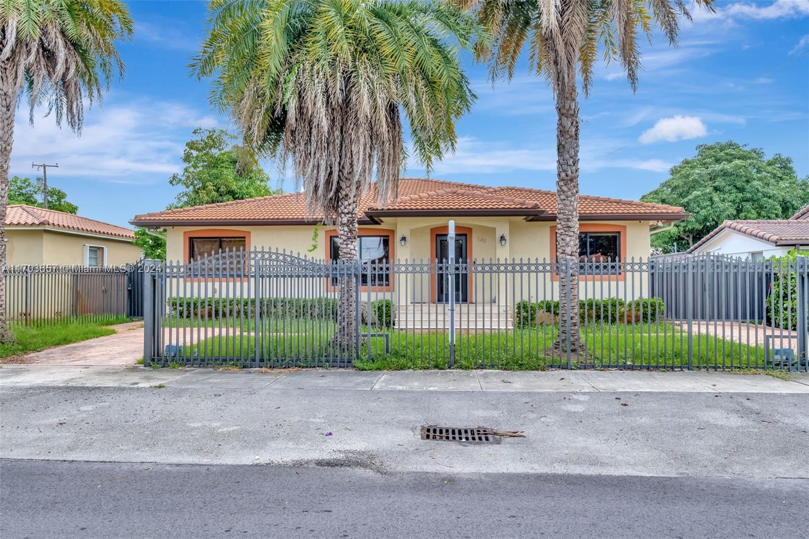 141 Southwest 51st Court, Unit 141 Miami, FL 33134 - Photo 1 of 38 a front view of a house with a garden and palm trees