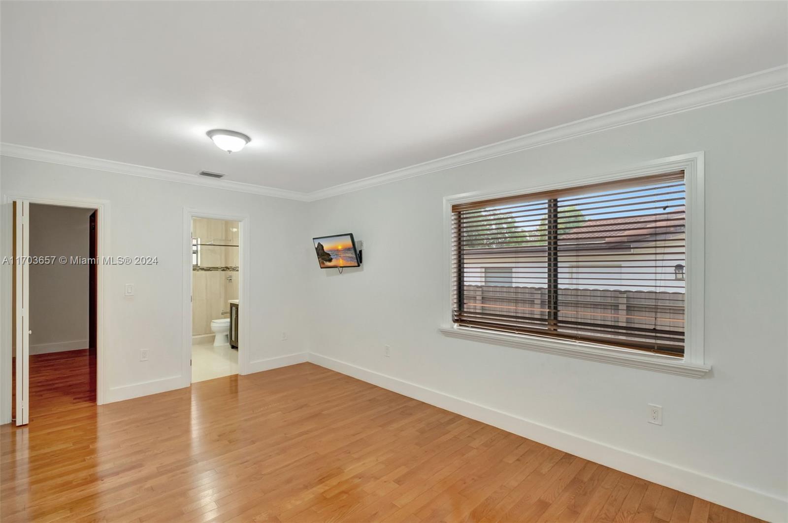 141 Southwest 51st Court, Unit 141 Miami, FL 33134 - Photo 18 of 38 a view of empty room with wooden floor and fan