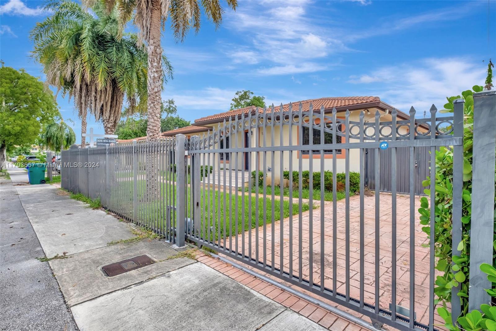 141 Southwest 51st Court, Unit 141 Miami, FL 33134 - Photo 2 of 38 a view of a street with a fence
