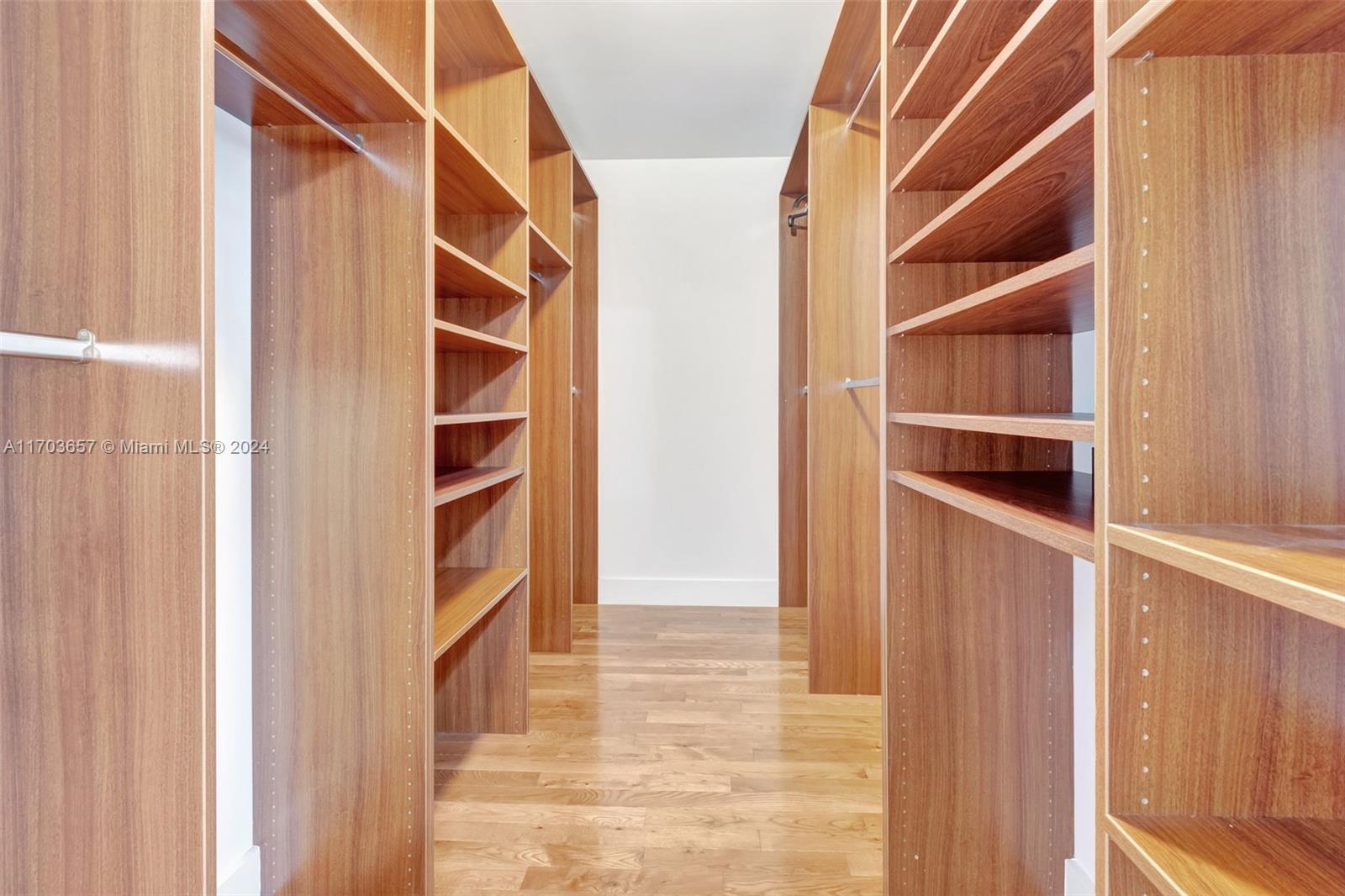 141 Southwest 51st Court, Unit 141 Miami, FL 33134 - Photo 22 of 38 a view of an empty room with wooden floor and a window