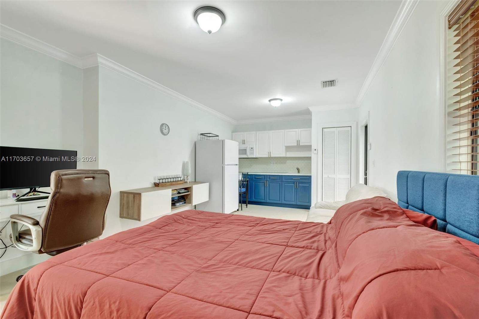 141 Southwest 51st Court, Unit 141 Miami, FL 33134 - Photo 27 of 38 a bedroom with a large bed and furniture