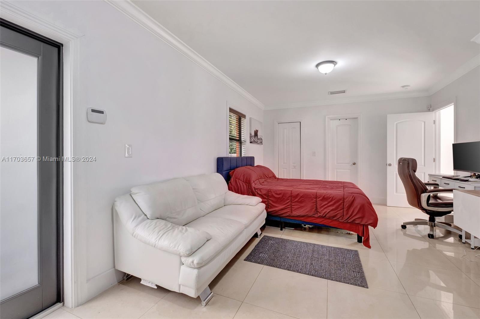 141 Southwest 51st Court, Unit 141 Miami, FL 33134 - Photo 29 of 38 a bedroom with a bed and a couch