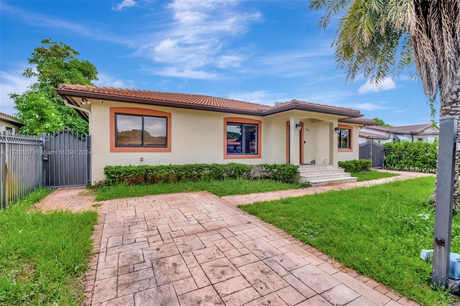 141 Southwest 51st Court, Unit 141 Miami, FL 33134 - Photo 3 of 38 a front view of a house with a yard and potted plants
