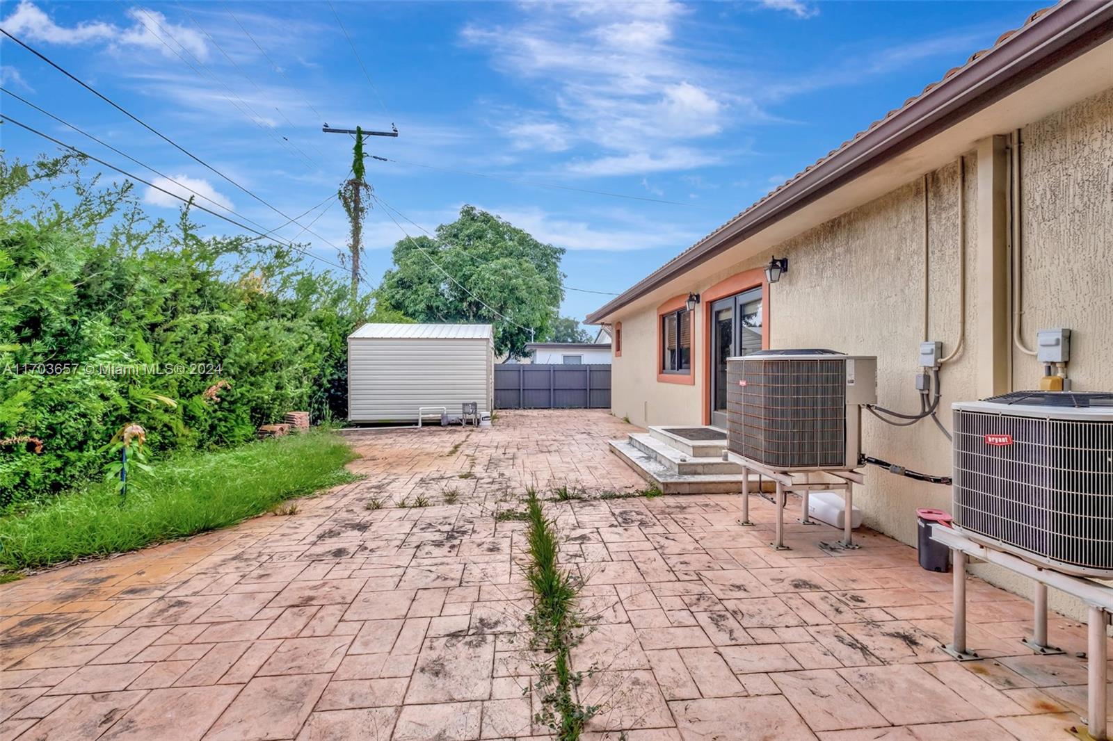 141 Southwest 51st Court, Unit 141 Miami, FL 33134 - Photo 34 of 38 a patio with a table and chairs and potted plants