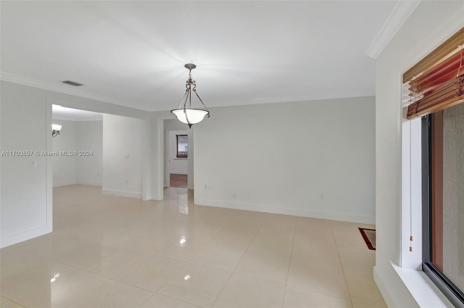 141 Southwest 51st Court, Unit 141 Miami, FL 33134 - Photo 5 of 38 wooden floor in an empty room with a window