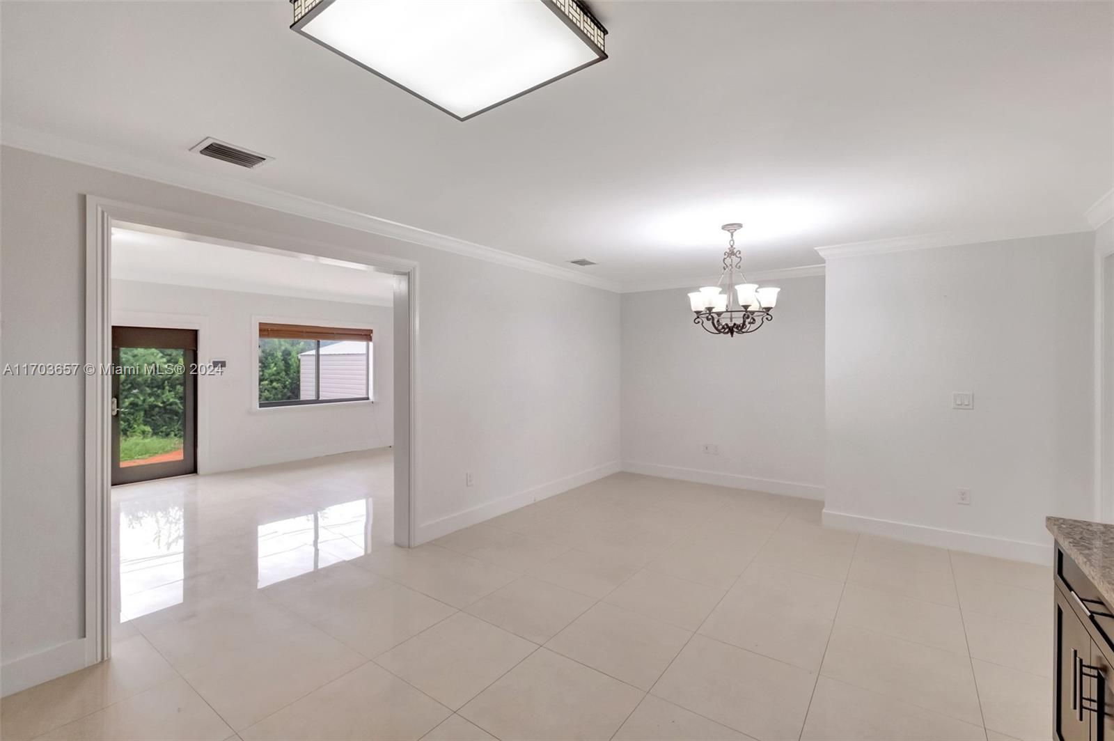 141 Southwest 51st Court, Unit 141 Miami, FL 33134 - Photo 9 of 38 an empty room with windows and entrance