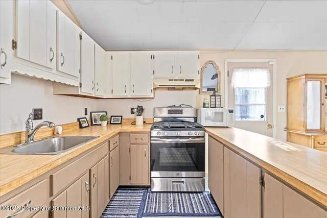 a kitchen with stainless steel appliances granite countertop a sink and cabinets