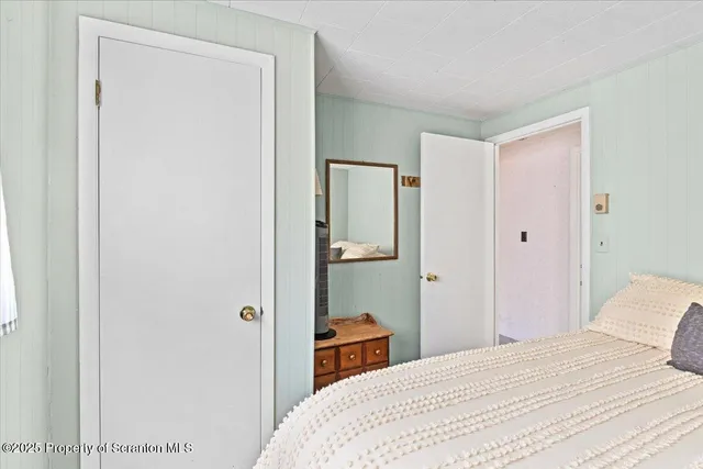 a bedroom with a bed and closet