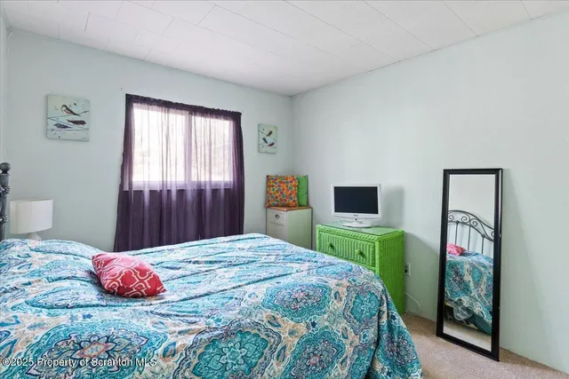 a bedroom with a bed and a television