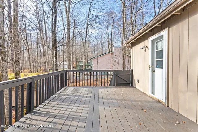 a view of a porch with wooden floor and fence