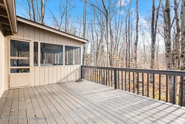 a view of a house with a wooden fence