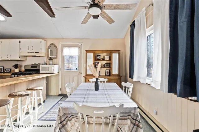 a large kitchen with kitchen island a large island in the center windows and furniture
