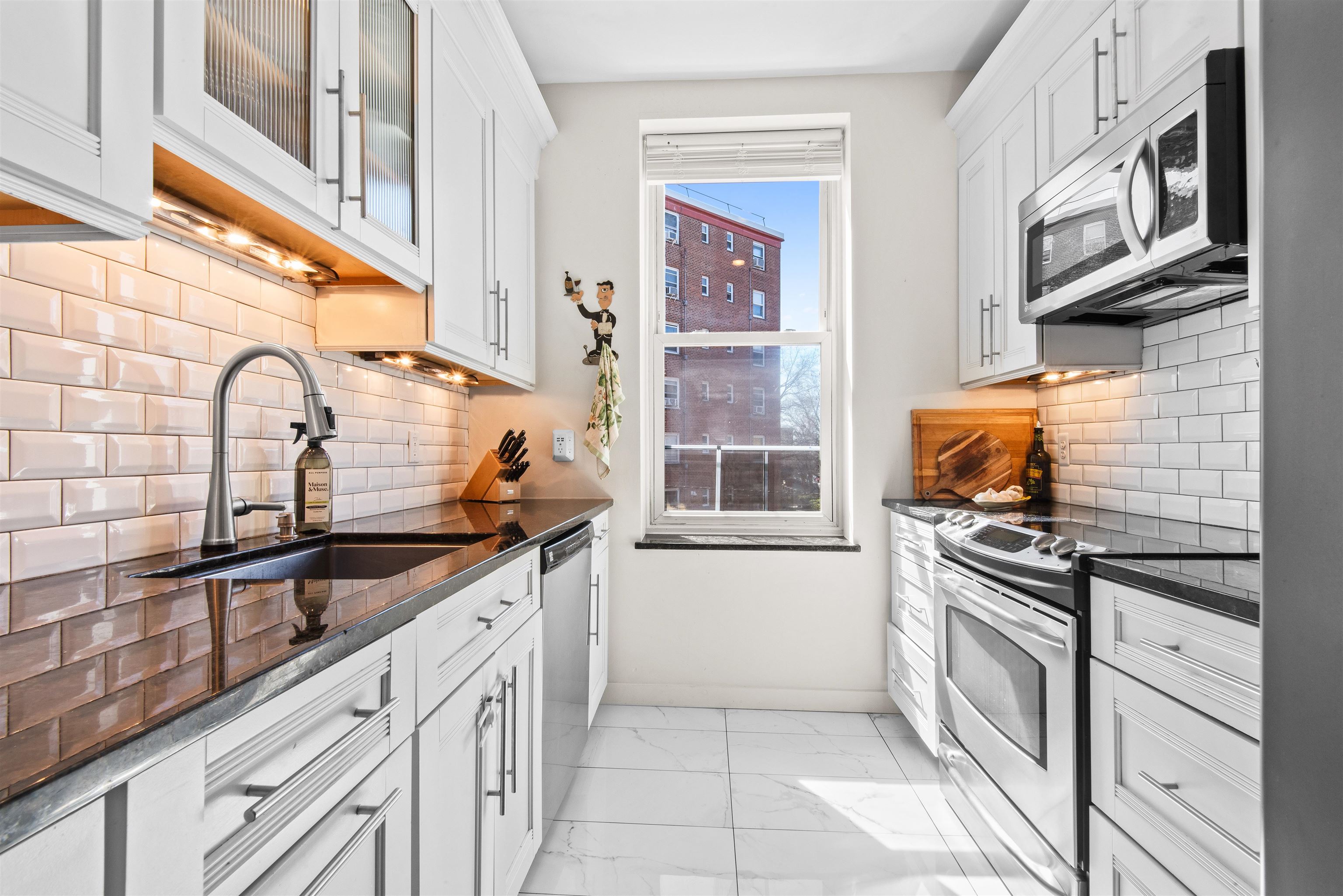 456 9th Street, Unit 9 Hoboken, NJ 07030 - Photo 13 of 29 a kitchen with stainless steel appliances granite countertop a sink stove and cabinets