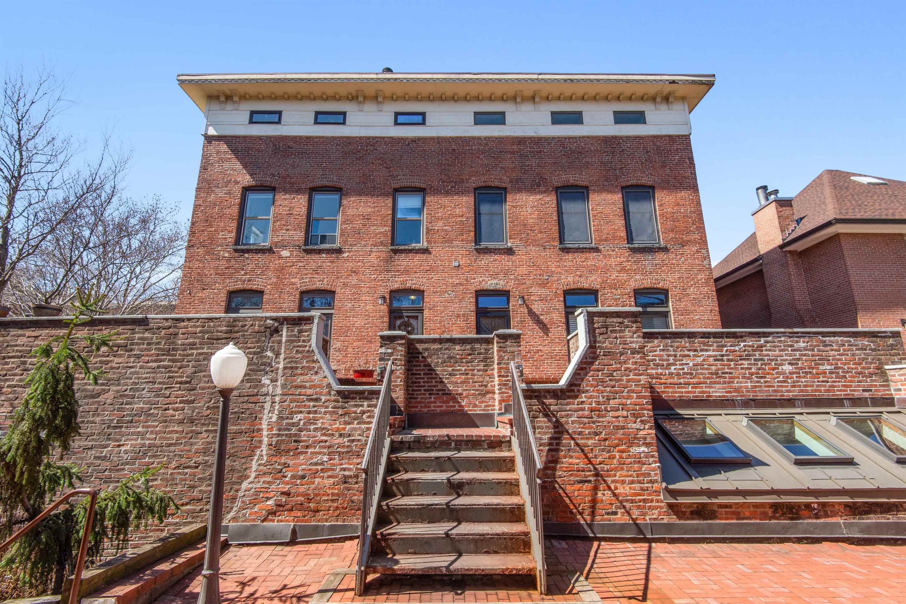 456 9th Street, Unit 9 Hoboken, NJ 07030 - Photo 25 of 29 a view of a brick house with large windows