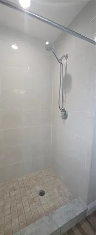 a view of a room with wooden floor and a window