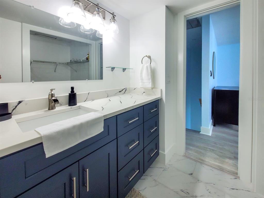 215 Medallion Boulevard, Unit G Madeira Beach, FL 33708 - Photo 17 of 29 a bathroom with a sink and a mirror