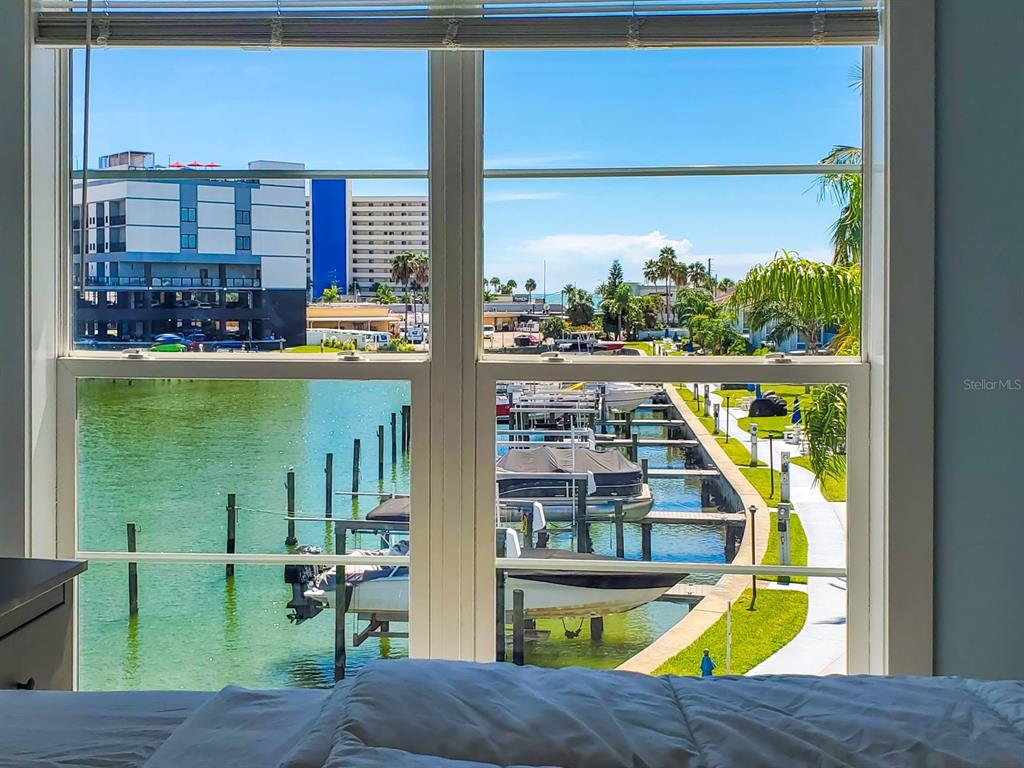 215 Medallion Boulevard, Unit G Madeira Beach, FL 33708 - Photo 19 of 29 a view of swimming pool from a window