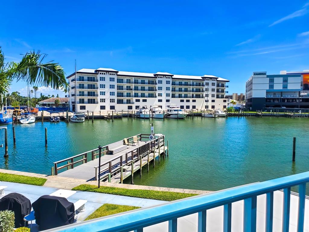 215 Medallion Boulevard, Unit G Madeira Beach, FL 33708 - Photo 21 of 29 a view of a lake with a building in the background