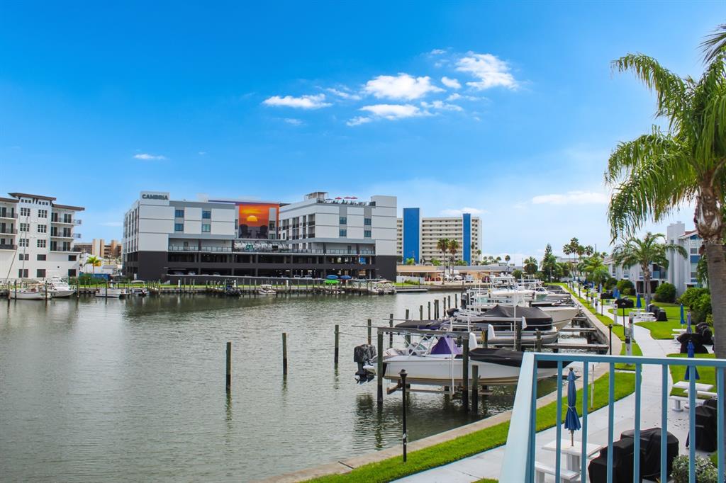 215 Medallion Boulevard, Unit G Madeira Beach, FL 33708 - Photo 26 of 29 a view of a chairs and table in a terrace