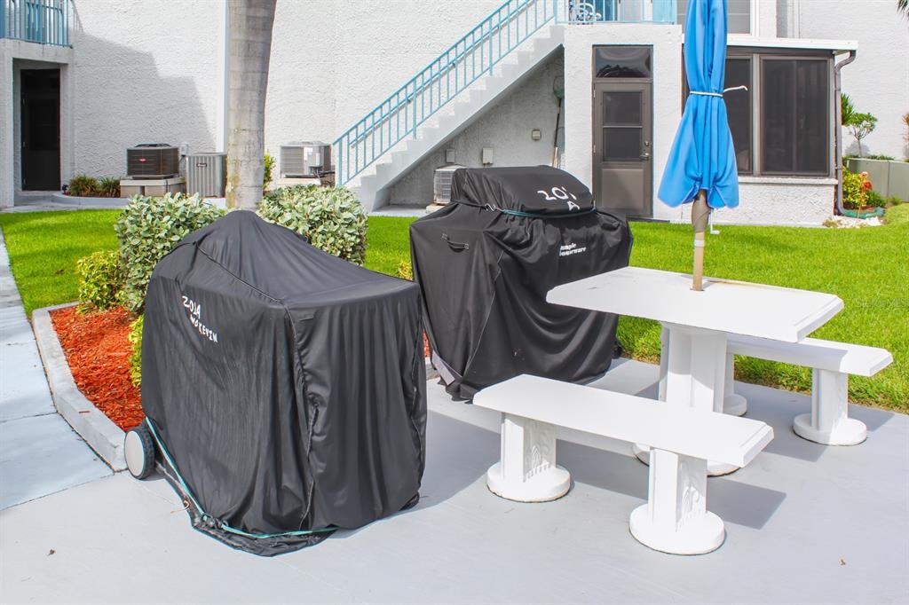 215 Medallion Boulevard, Unit G Madeira Beach, FL 33708 - Photo 28 of 29 a view of outdoor dining space in the backyard