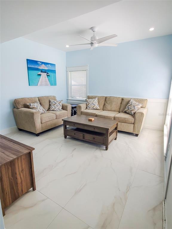 215 Medallion Boulevard, Unit G Madeira Beach, FL 33708 - Photo 4 of 29 a living room with furniture and a couch